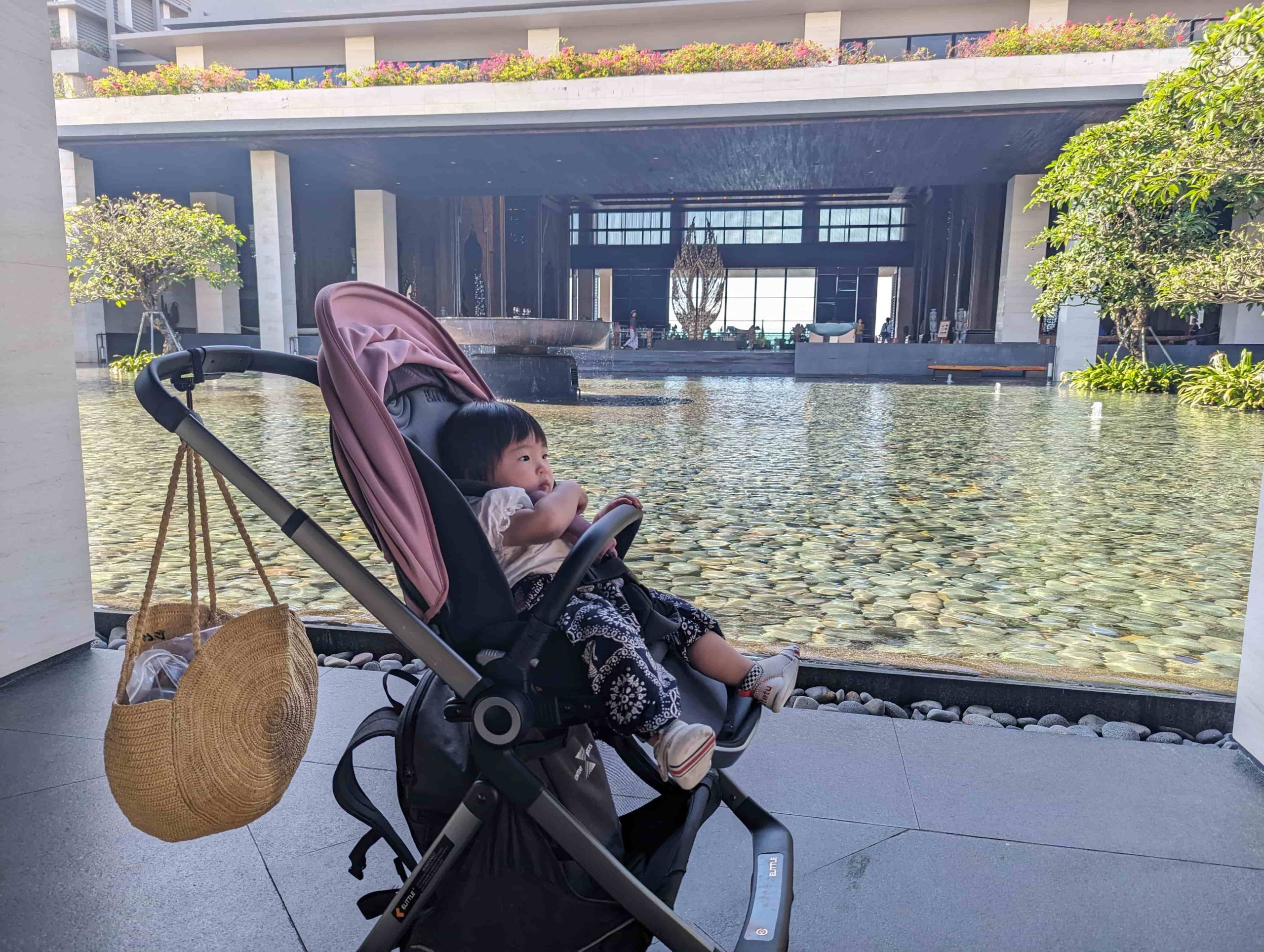 Toddler in stroller at a luxury resort lobby in Nusa Dua, Bali