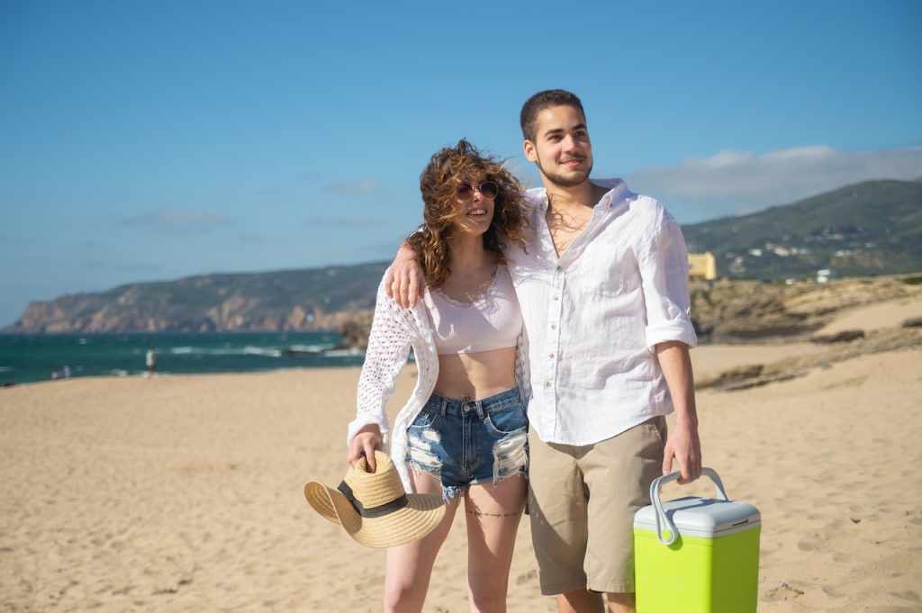 Couple holding beach cooler