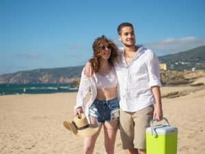 Couple holding beach cooler