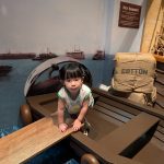 Toddler climbing on a boat replica at Children's Museum Singapore