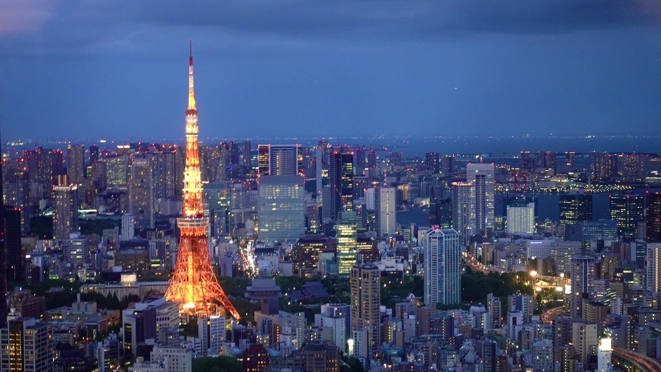 Tokyo Tower illuminated at night with city skyline in the background