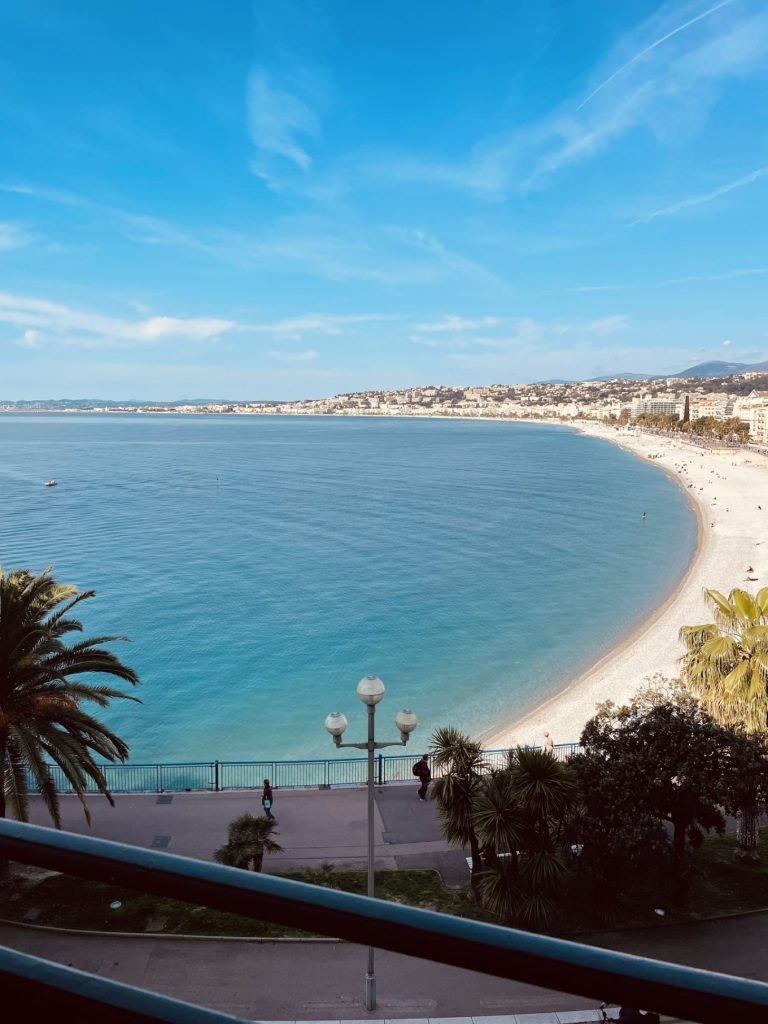 Hotel Suisse Nice Review: Iconic Sea Views on the French Riviera 12 Clear view of turquoise Mediterranean waters from Hôtel Suisse Nice arched balcony.