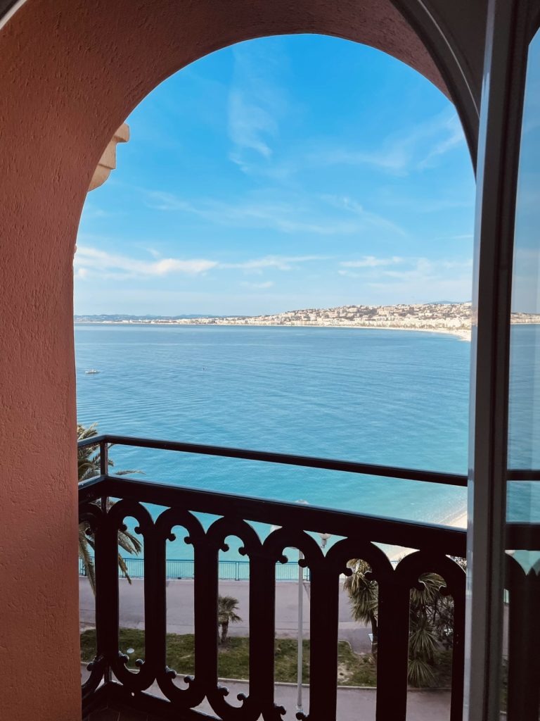 Hotel Suisse Nice Review: Iconic Sea Views on the French Riviera 14 Clear view of turquoise Mediterranean waters from Hôtel Suisse Nice arched balcony.
