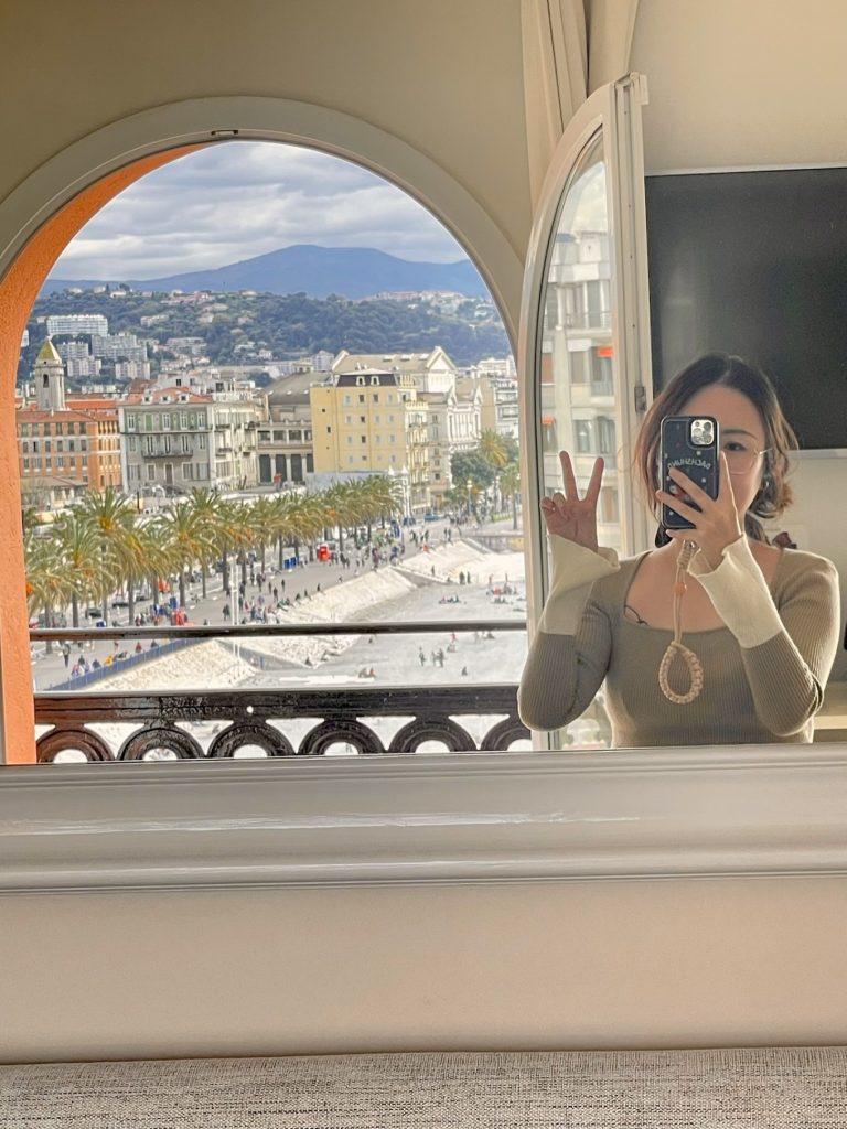 Hotel Suisse Nice Review: Iconic Sea Views on the French Riviera 15 Evening view of Nice coastline and Promenade des Anglais from Hôtel Suisse Nice arched balcony.