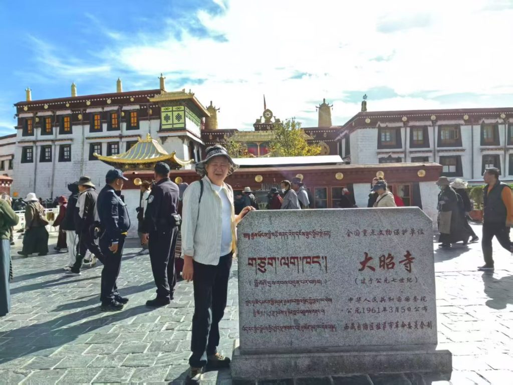 Family visiting Jokhang Temple square in Lhasa