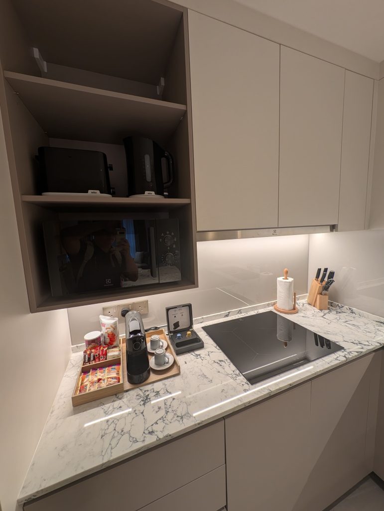 Marriott Executive Apartments Kuala Lumpur Review: Our 2-Night Family Stay 7 Kitchen counter with Nespresso machine, coffee capsules, toaster, and stovetop at Marriott Executive Apartments Kuala Lumpur.