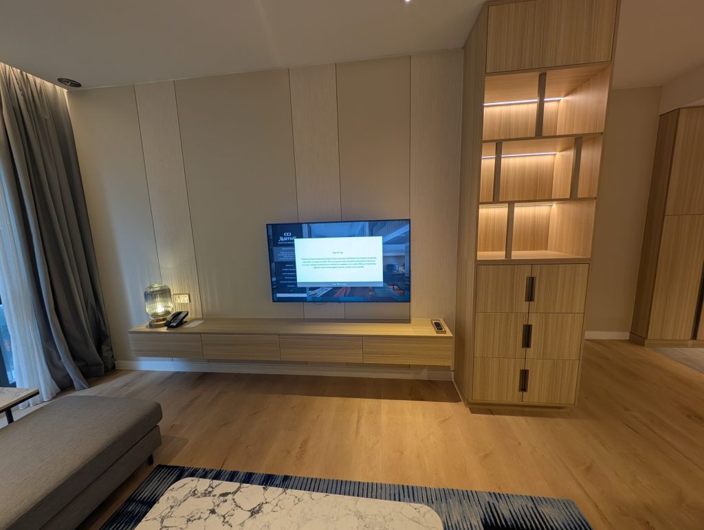 Marriott Executive Apartments Kuala Lumpur Review: Our 2-Night Family Stay 9 Floating TV console and built-in wooden shelving in the living room of Marriott Executive Apartments Kuala Lumpur.
