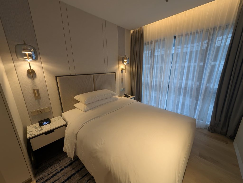 Marriott Executive Apartments Kuala Lumpur Review: Our 2-Night Family Stay 12 Comfortable king bed with soft ambient lighting and full-height sheer curtains at Marriott Executive Apartments Kuala Lumpur.