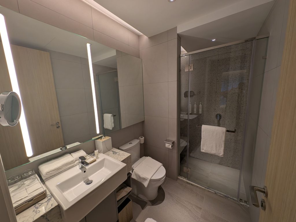 Marriott Executive Apartments Kuala Lumpur Review: Our 2-Night Family Stay 16 Modern bathroom with LED vanity mirror and glass-enclosed shower at Marriott Executive Apartments Kuala Lumpur.