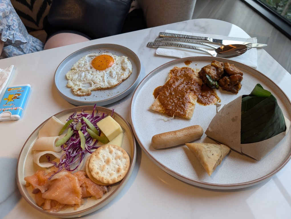 Marriott Executive Apartments Kuala Lumpur Review: Our 2-Night Family Stay 23 Assorted breakfast items including eggs, curry chicken, nasi lemak, smoked salmon, and salad at Marriott Executive Apartments Kuala Lumpur.