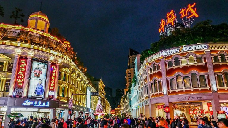 Pedestrian shoppers walking past European-style buildings along Zhongshan Road in Qingdao.