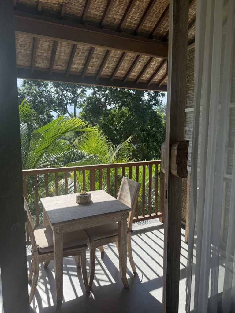 The Sun of Granary Resort and Villas Review: Family Stay Amid Ubud’s Rice Fields 5 Wooden balcony overlooking tropical trees and rice paddies in Ubud, Bali