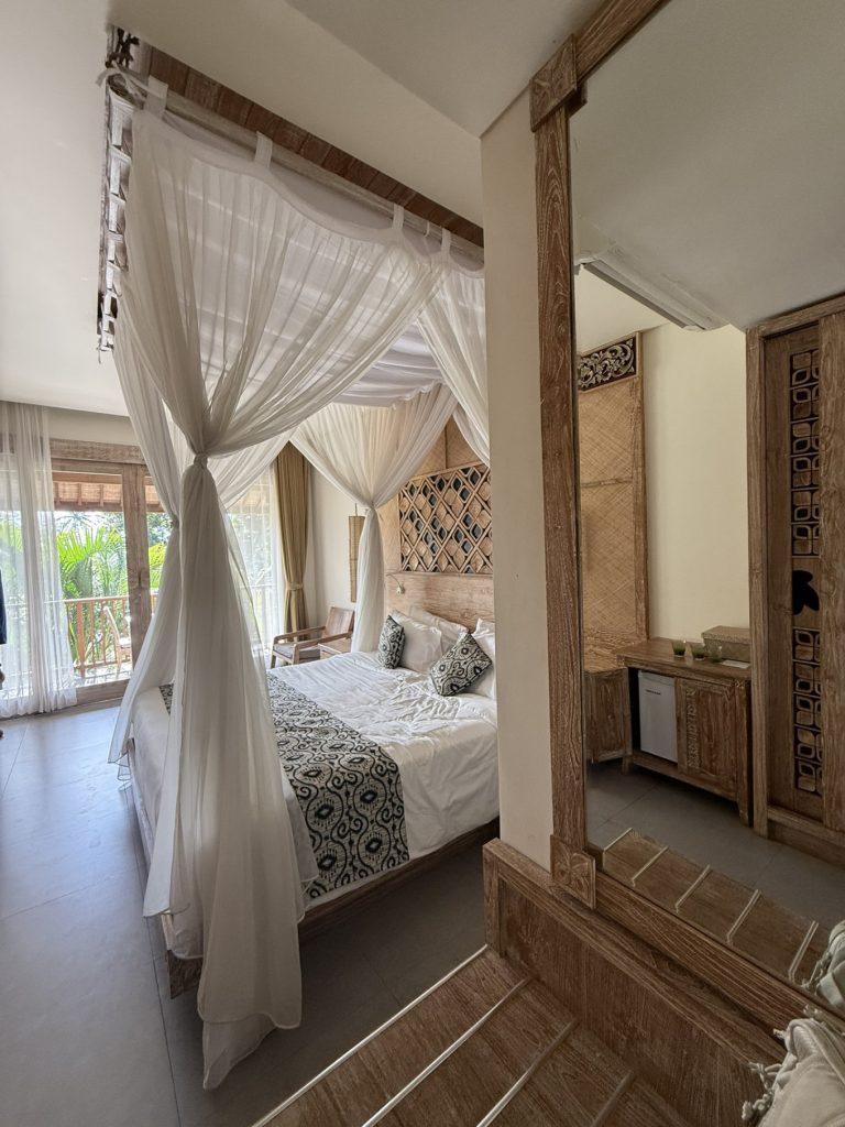 The Sun of Granary Resort and Villas Review: Family Stay Amid Ubud’s Rice Fields 6 Cozy wooden bedroom with canopy bed at The Sun of Granary Resort Ubud)