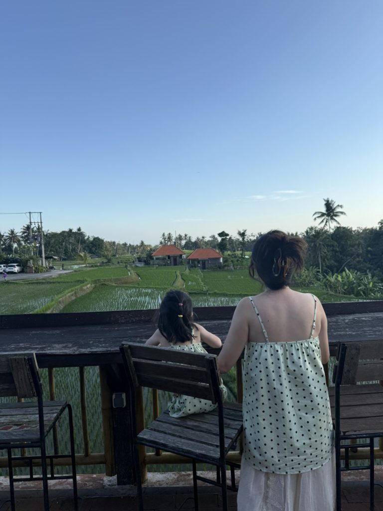 The Sun of Granary Resort and Villas Review: Family Stay Amid Ubud’s Rice Fields 10 Family enjoying rice field view from café at The Sun of Granary Ubud