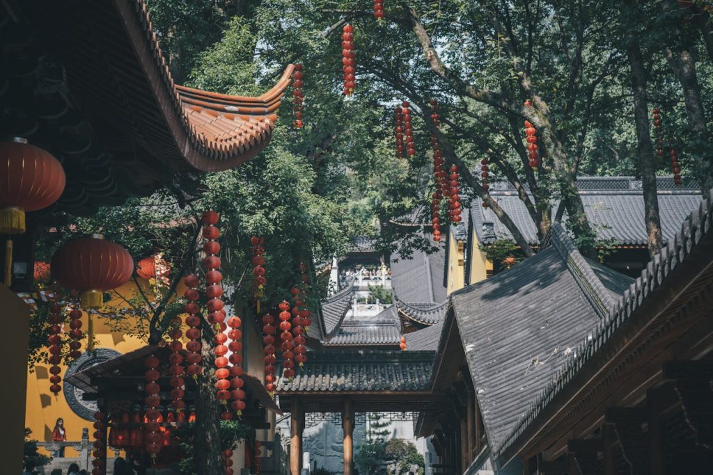 Best Cities in China for Shopping: Where to Go for Luxury, Bargains & Local Finds 11 Traditional Chinese temple courtyard with red lanterns hanging among trees