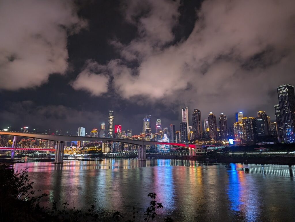 Chongqing skyline at night with illuminated bridges and skyscrapers reflected on the river