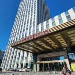 Crowne Plaza Harbin Songbei hotel exterior and main entrance beneath a clear blue sky