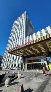 Crowne Plaza Harbin Songbei hotel exterior and main entrance beneath a clear blue sky