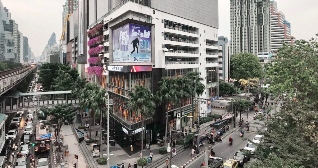 Where to Stay in Sukhumvit Bangkok: Best Areas, Hotels & Travel Tips 10 Ekkamai neighborhood in Sukhumvit with modern residential buildings and city traffic in Bangkok