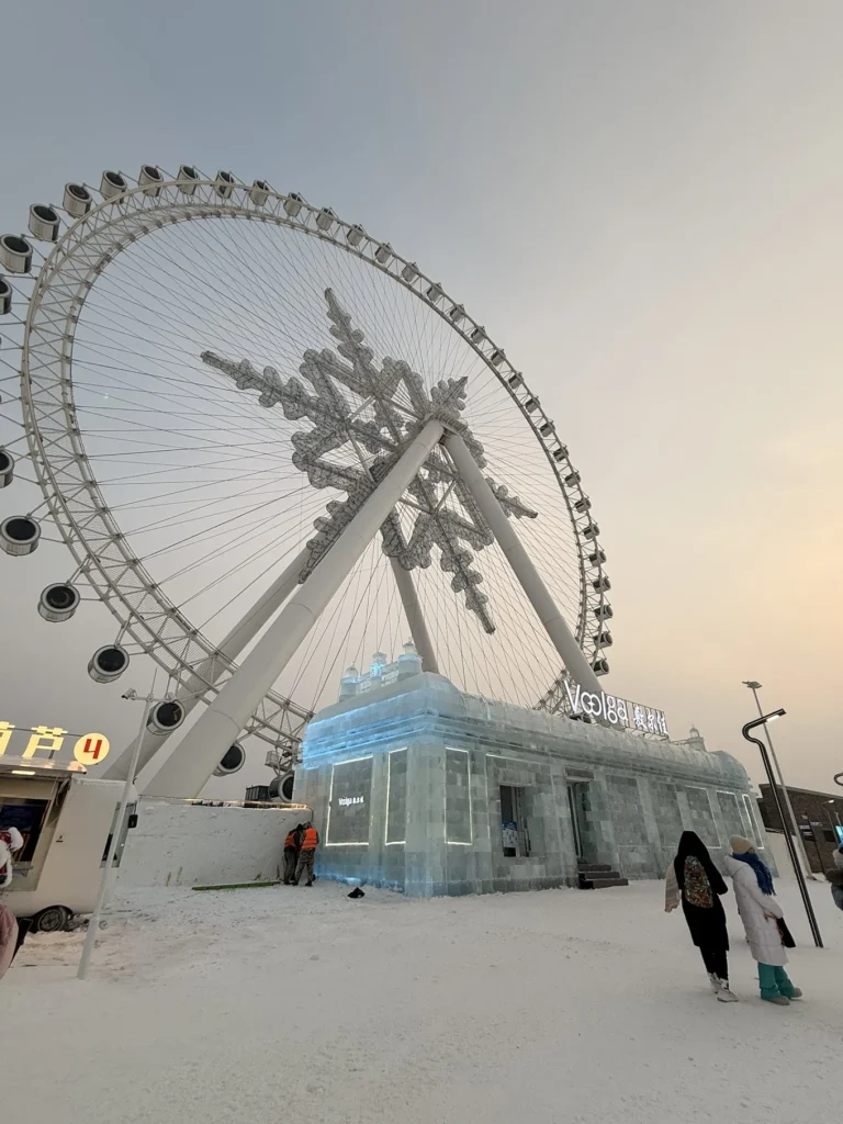Visit to Harbin Ice and Snow World: What It’s Really Like 8 Ferris wheel at Harbin Ice and Snow World during winter sunset