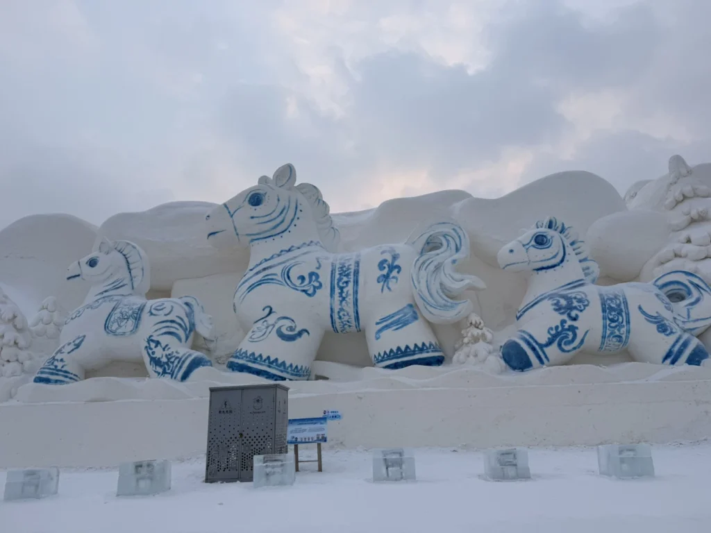 Visit to Harbin Ice and Snow World: What It’s Really Like 12 Snow sculpture of blue-and-white horses at Harbin Ice and Snow World