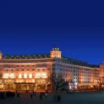Hotel Indigo Harbin Central Avenue illuminated at night beside the historic European-style buildings of Central Street
