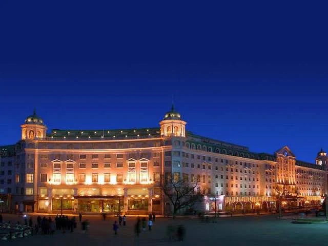 Hotel Indigo Harbin Central Avenue illuminated at night beside the historic European-style buildings of Central Street