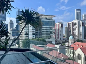 Rooftop pool at Mercure Singapore Bugis overlooking the city skyline and historic architecture in central Singapore.