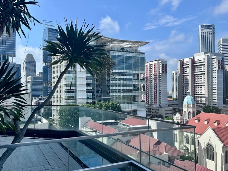 Rooftop pool at Mercure Singapore Bugis overlooking the city skyline and historic architecture in central Singapore.