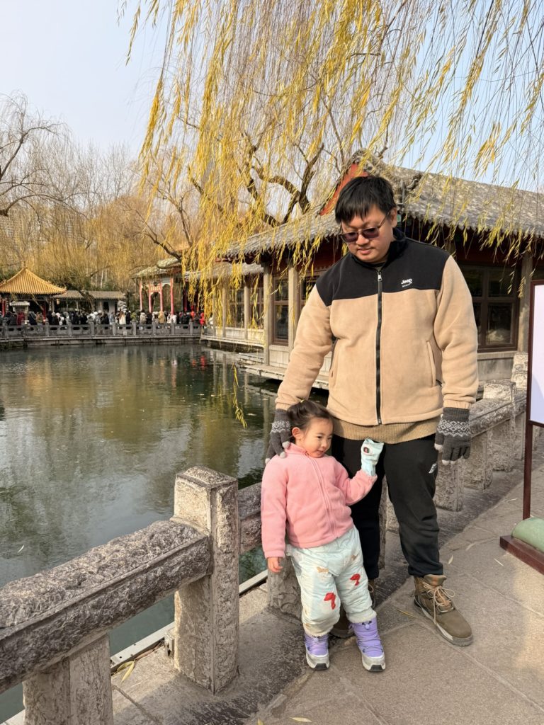 Baotu Spring Travel Guide: Visiting Jinan’s No.1 Spring 13 Family visiting Baotu Spring with child standing beside the spring water