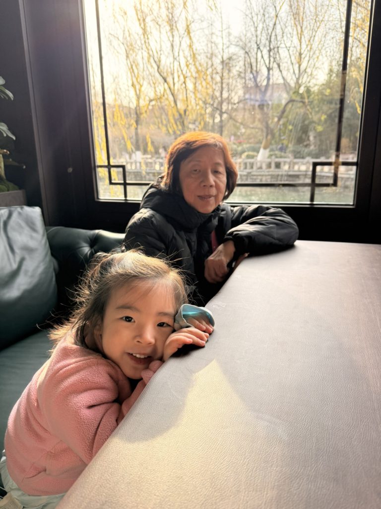 Baotu Spring Travel Guide: Visiting Jinan’s No.1 Spring 10 Child and elderly family member resting indoors near Baotu Spring on a winter afternoon