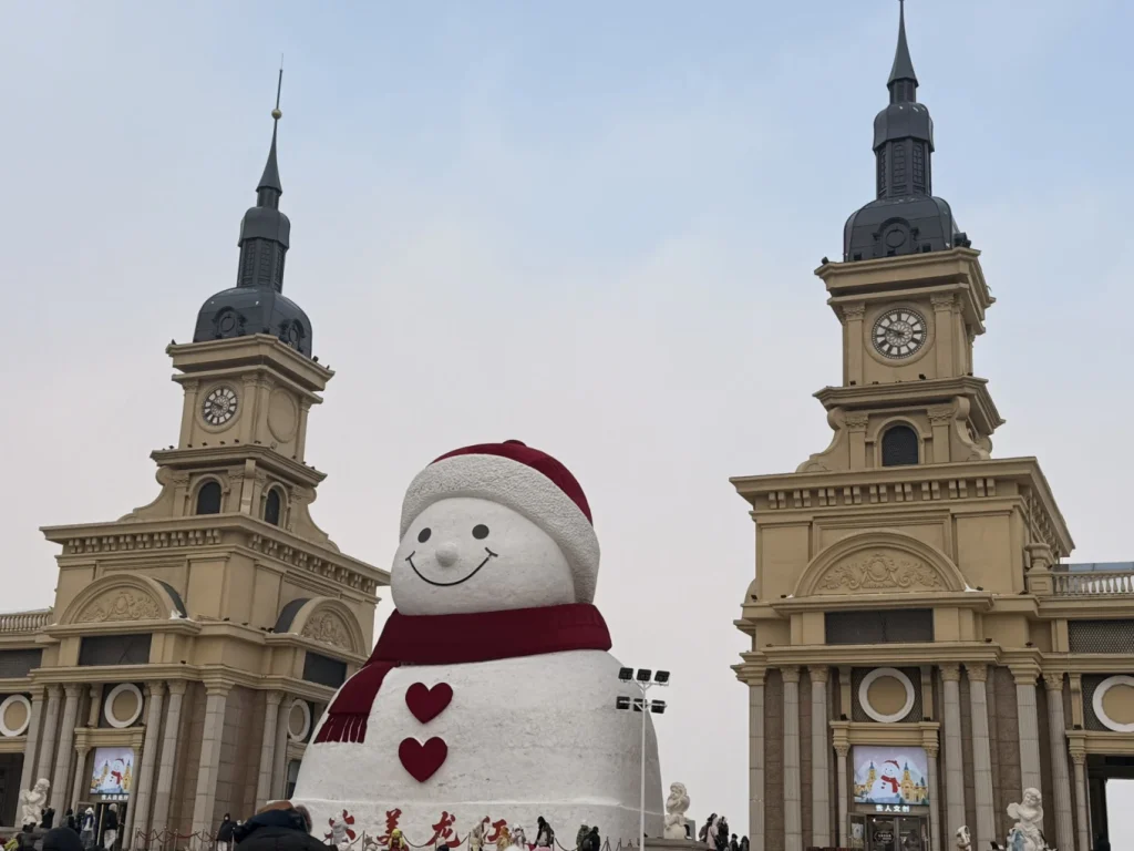 Visiting Harbin’s Music Corridor Giant Snowman in Winter 6 Close-up view of the Music Corridor Giant Snowman framed by historic buildings in Harbin