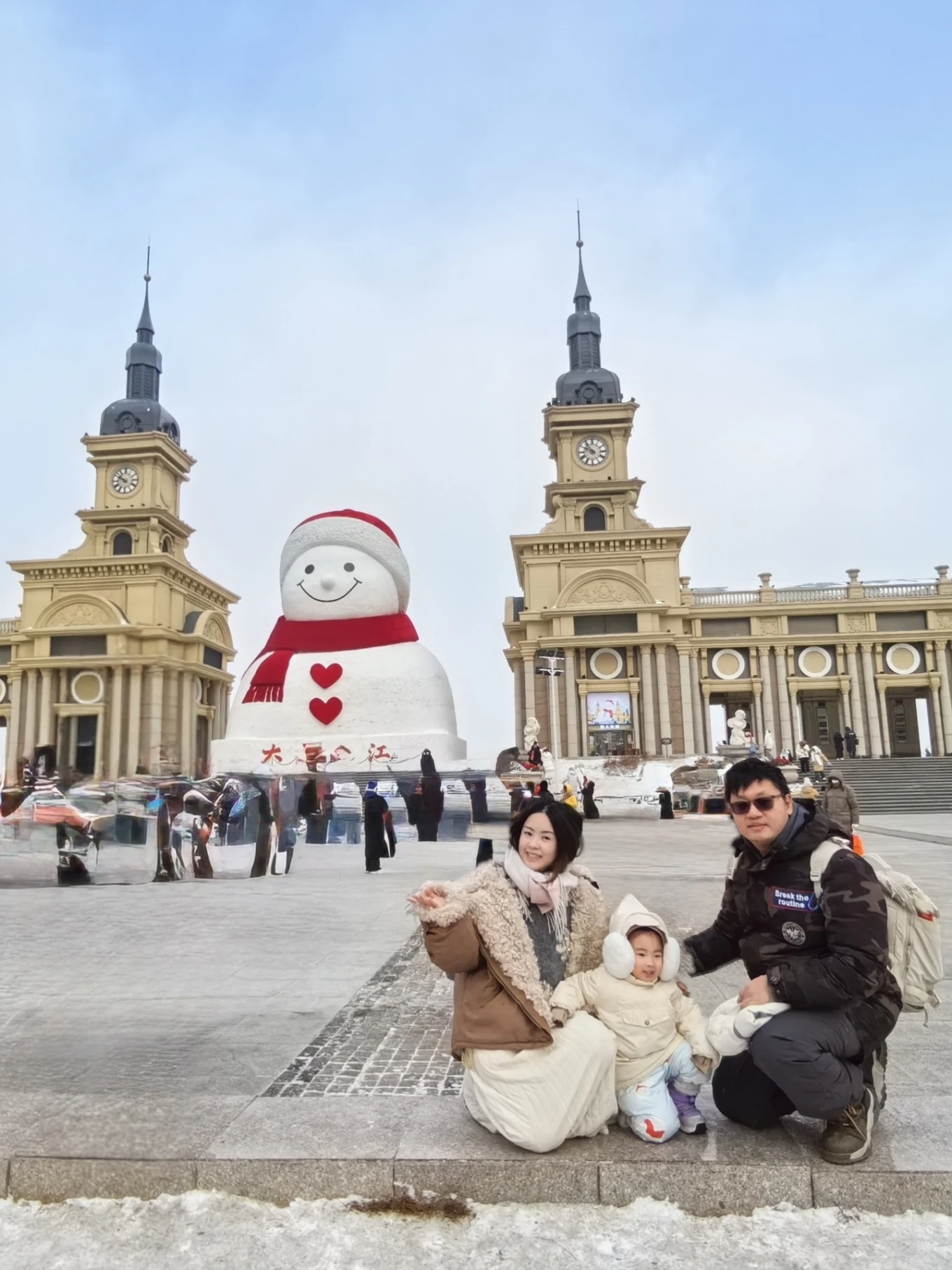 Family photo at the Music Corridor Giant Snowman in Harbin during winter