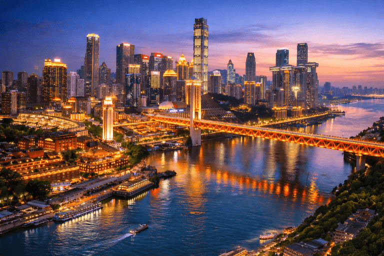 Chongqing skyline at night along the Yangtze River, showing Jiefangbei city center, illuminated bridges, and riverfront skyline