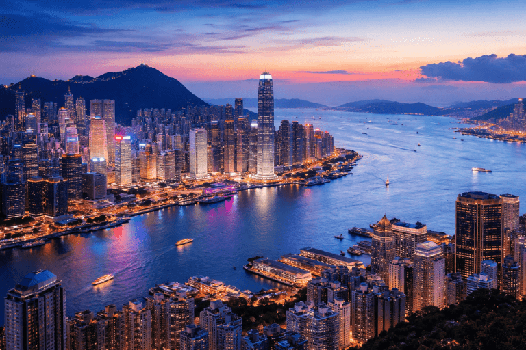 Hong Kong skyline at dusk with Victoria Harbour, showing Hong Kong Island and Kowloon