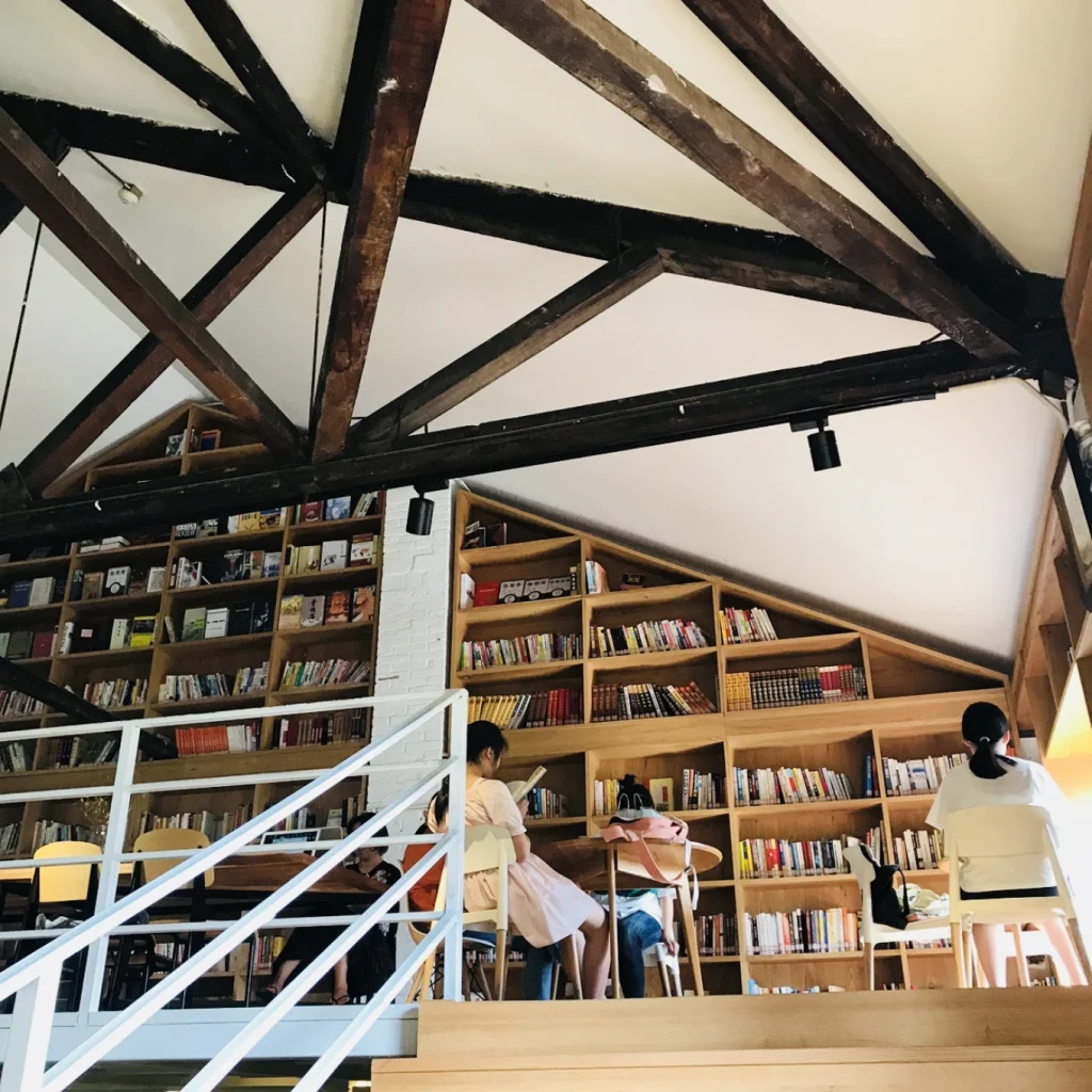 Beicang Creative Cultural District in Chongqing Near Guanyinqiao 13 Interior of a bookstore cafe at Beicang Creative Cultural District with wooden shelves and readers