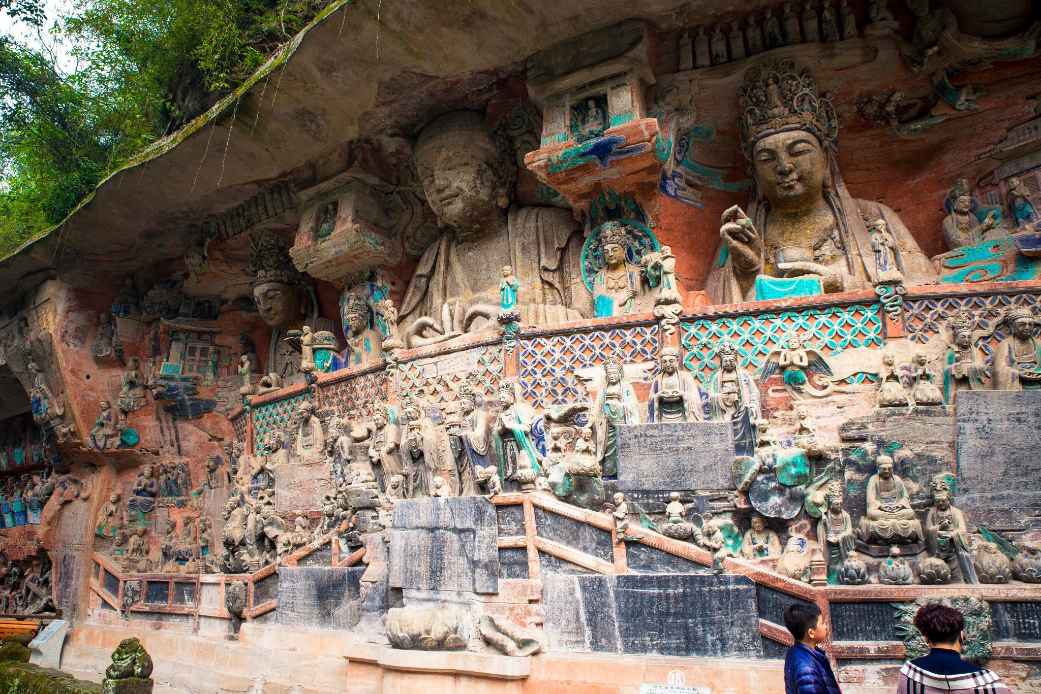 Large cliffside Buddhist statues and colorful relief carvings at Baodingshan in the Dazu Rock Carvings, Chongqing.