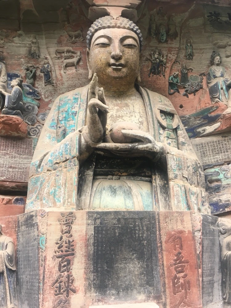 Dazu Rock Carvings Chongqing: Complete Guide to the UNESCO Buddhist Site 5 Close-up of ancient Buddha statue with faded turquoise pigment at Dazu Rock Carvings in Chongqing.