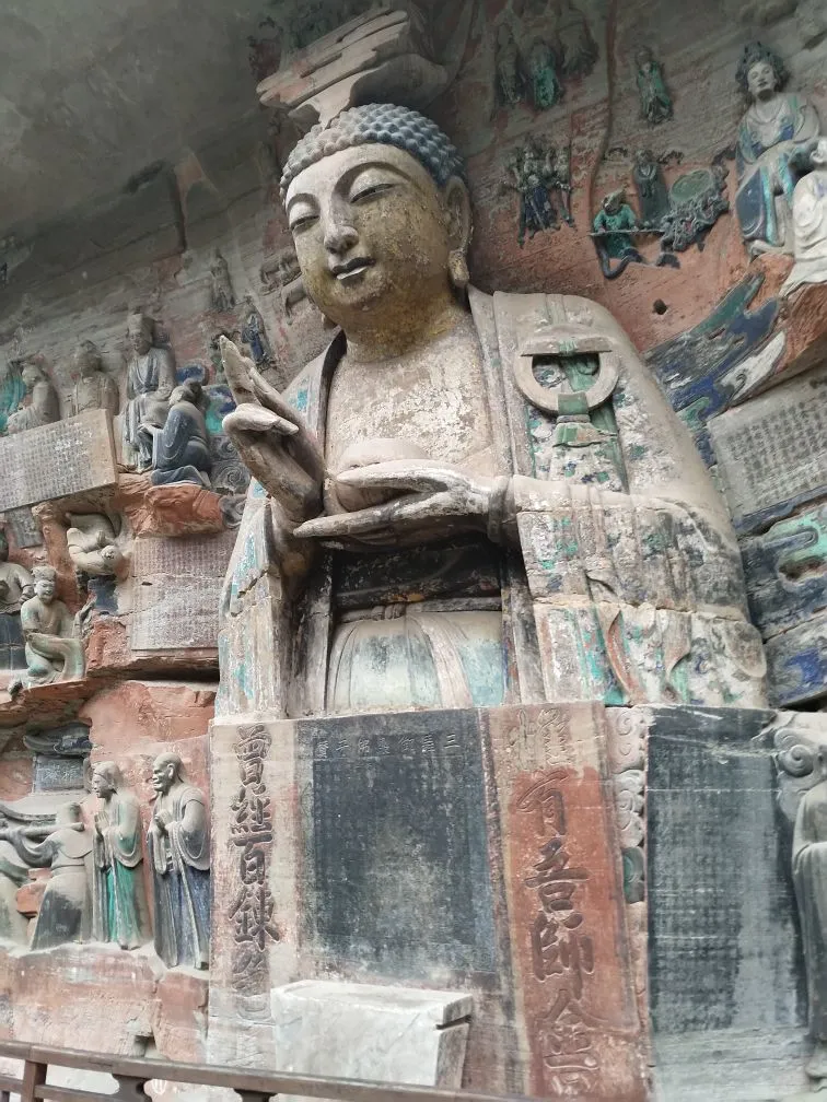 Dazu Rock Carvings Chongqing: Complete Guide to the UNESCO Buddhist Site 10 Side-angle view of seated Buddha statue carved into cliff at Baodingshan Dazu Rock Carvings.