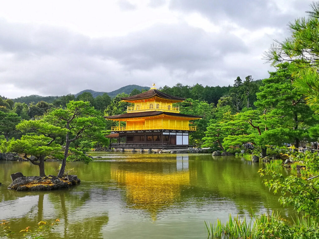 Golden Temple Kyoto Guide: Kinkaku-ji Travel Tips & History 7 Golden Temple Kyoto reflecting clearly in still pond water with vibrant green trees