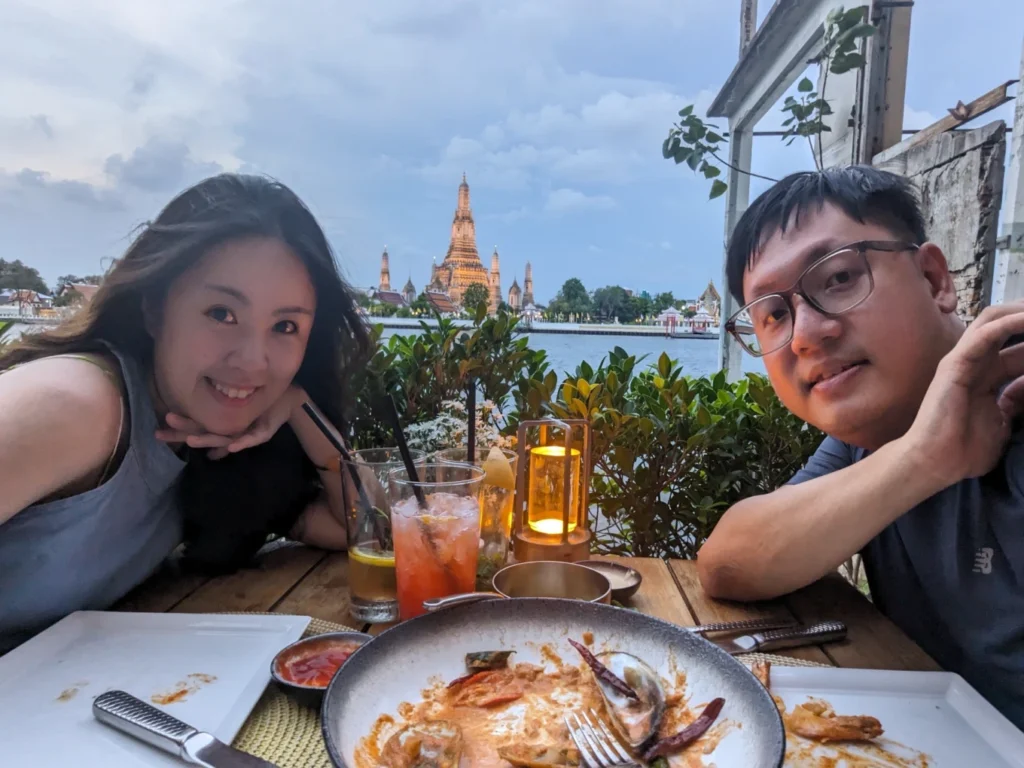 sala rattanakosin eatery and bar Review: Riverside Dining in Bangkok 2 Couple enjoying dinner at sala rattanakosin eatery and bar with Wat Arun glowing across the river