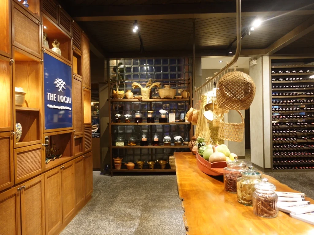 Traditional Thai décor and wine wall inside The Local Bangkok restaurant