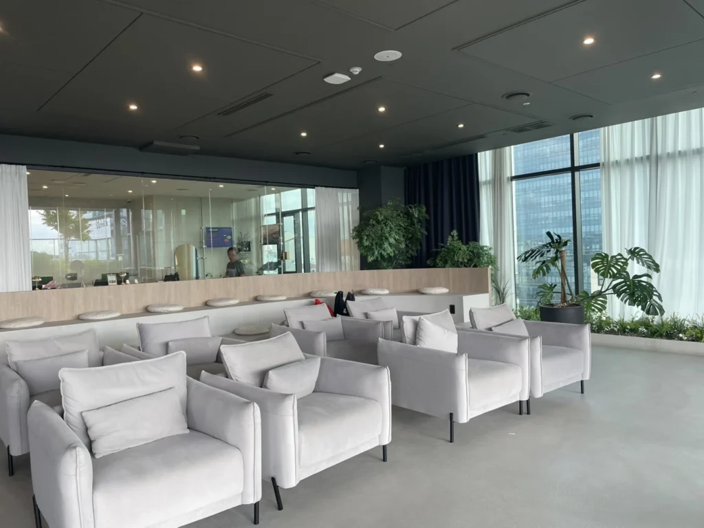Union Hotel Seoul reception lounge seating area with indoor plants and natural light