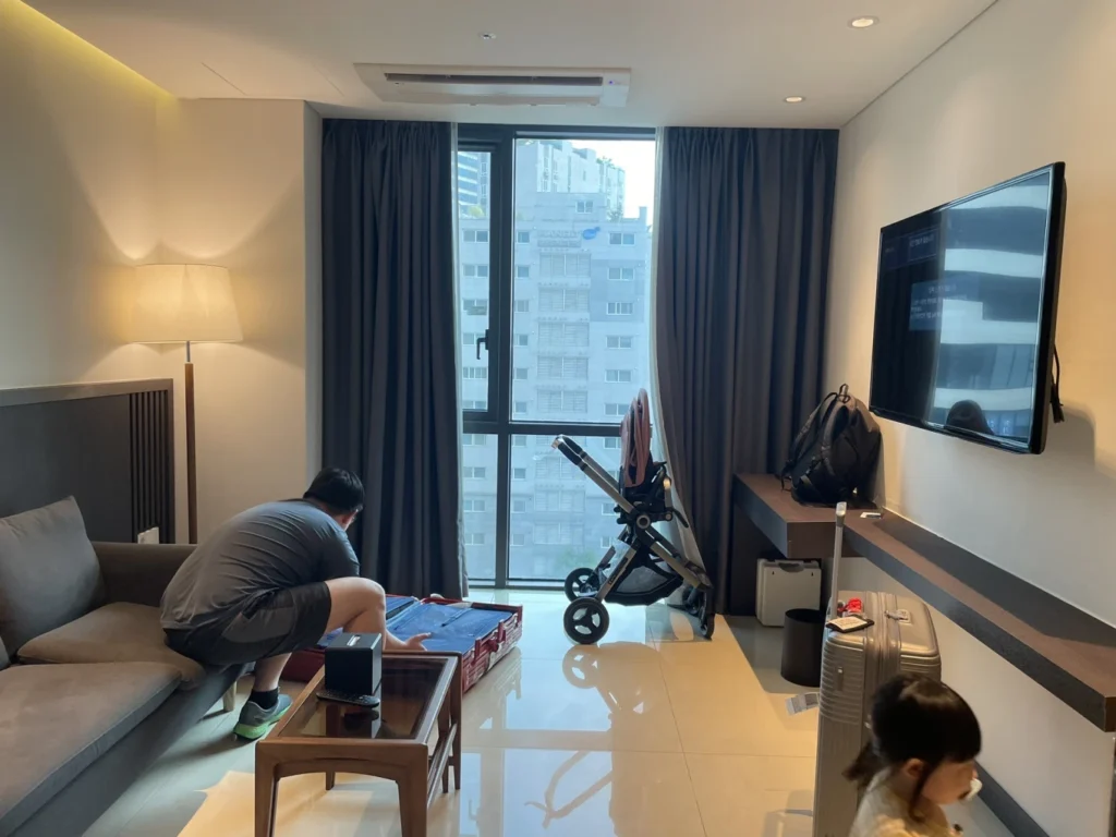 Union Hotel Seoul connecting room living area with sofa, stroller and luggage space