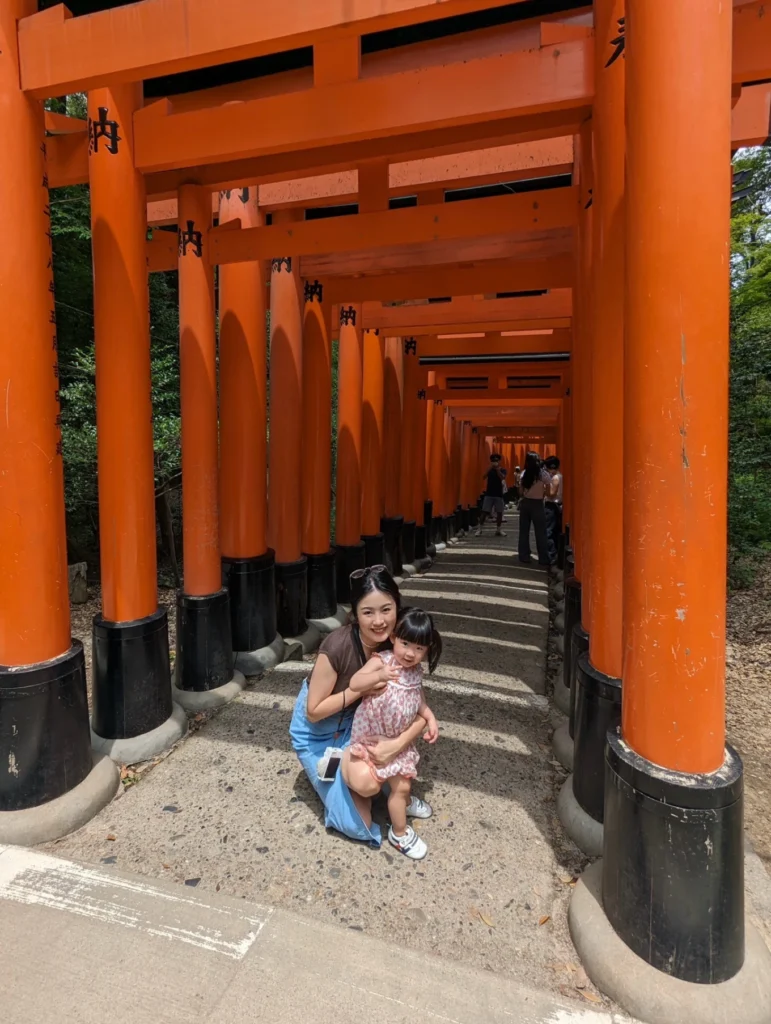 family posing under torii gates Fushimi Inari Taisha Kyoto less crowded trail