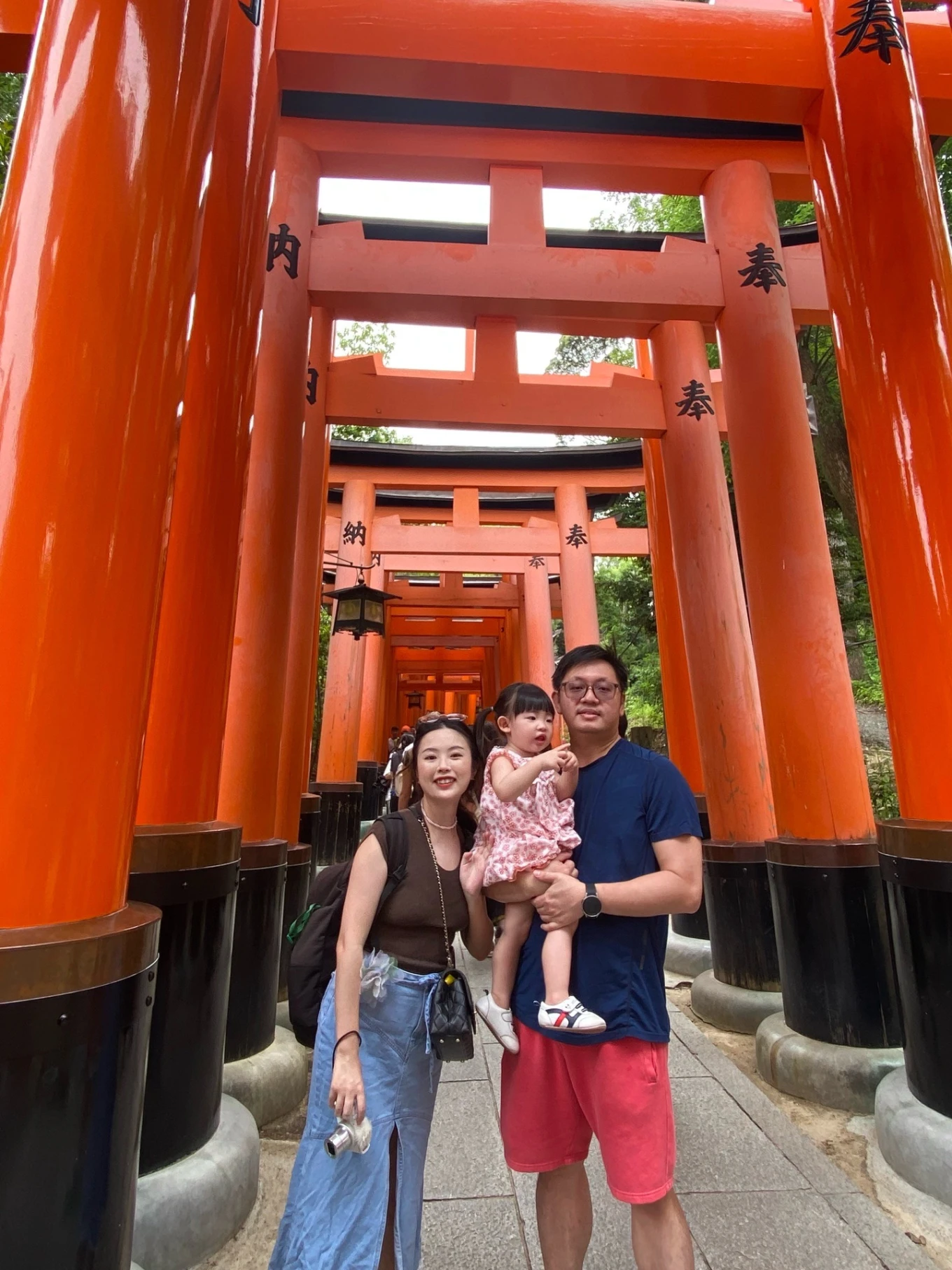 family photo under torii gates Fushimi Inari Taisha Kyoto Japan shrine pathway
