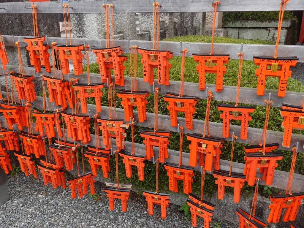 ema plaques shaped like torii gates Fushimi Inari Taisha Kyoto wishes
