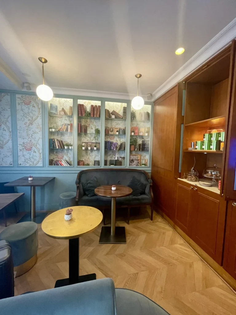 Hôtel De Neuve by HappyCulture Review: Boutique Charm in Le Marais 6 Small tea lounge area at Hôtel De Neuve by HappyCulture with built-in bookshelves and herringbone flooring