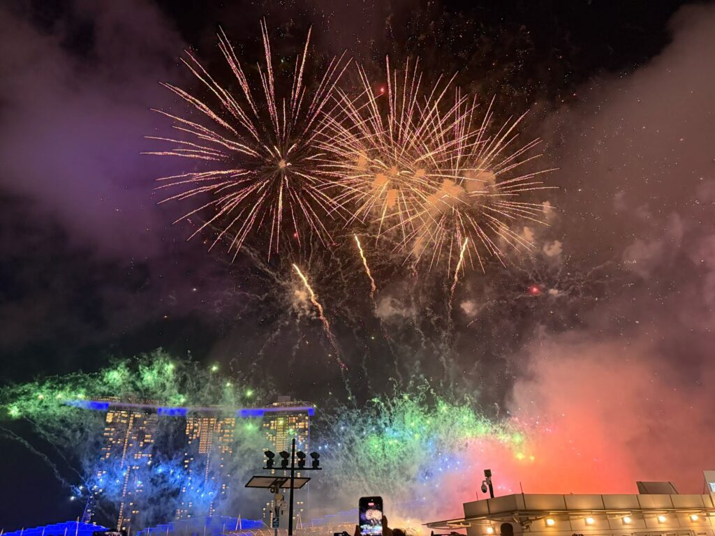 Disney Fireworks and Drone Show at Marina Bay Singapore (Family Experience Guide) 6 Colorful Disney fireworks over Marina Bay Sands with rainbow smoke during Singapore drone and fireworks show