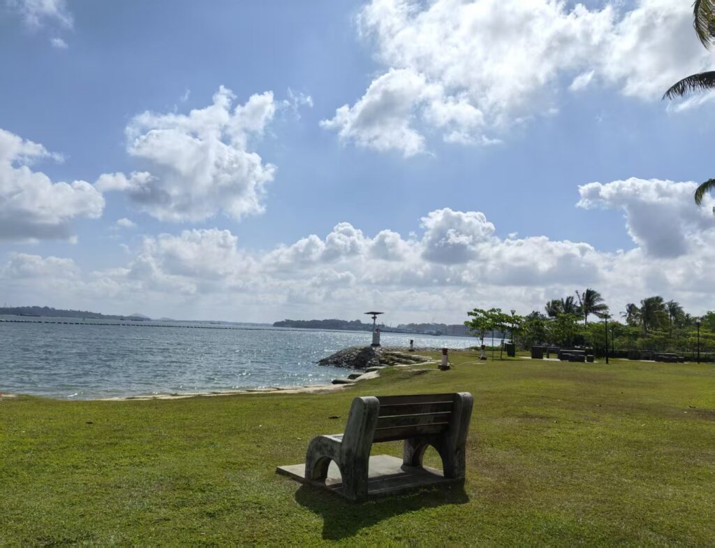 Pasir Ris Park Singapore Guide: Things to Do, Tips & Family Experience 6 Bench facing the sea at Pasir Ris Park Singapore on a sunny morning
